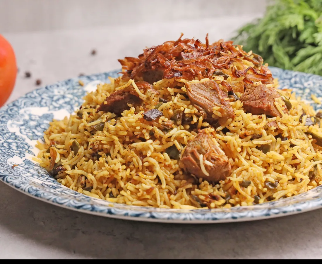 Lamb biryani topped with crispy fried onions