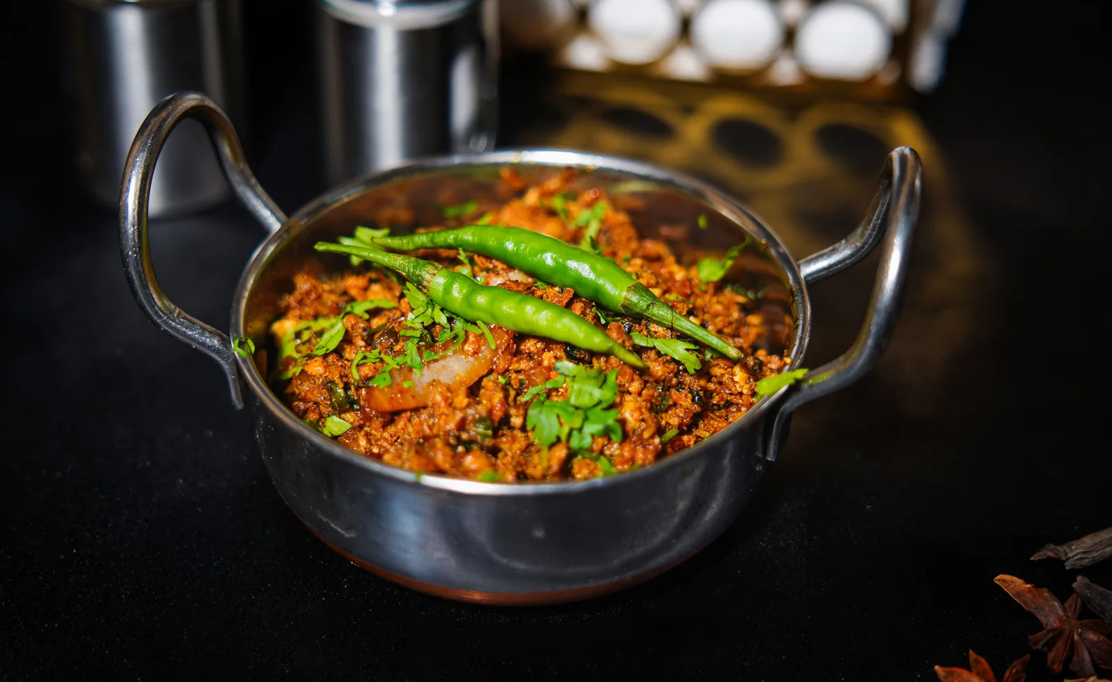 Spiced minced dish in a karahi topped with green chillies