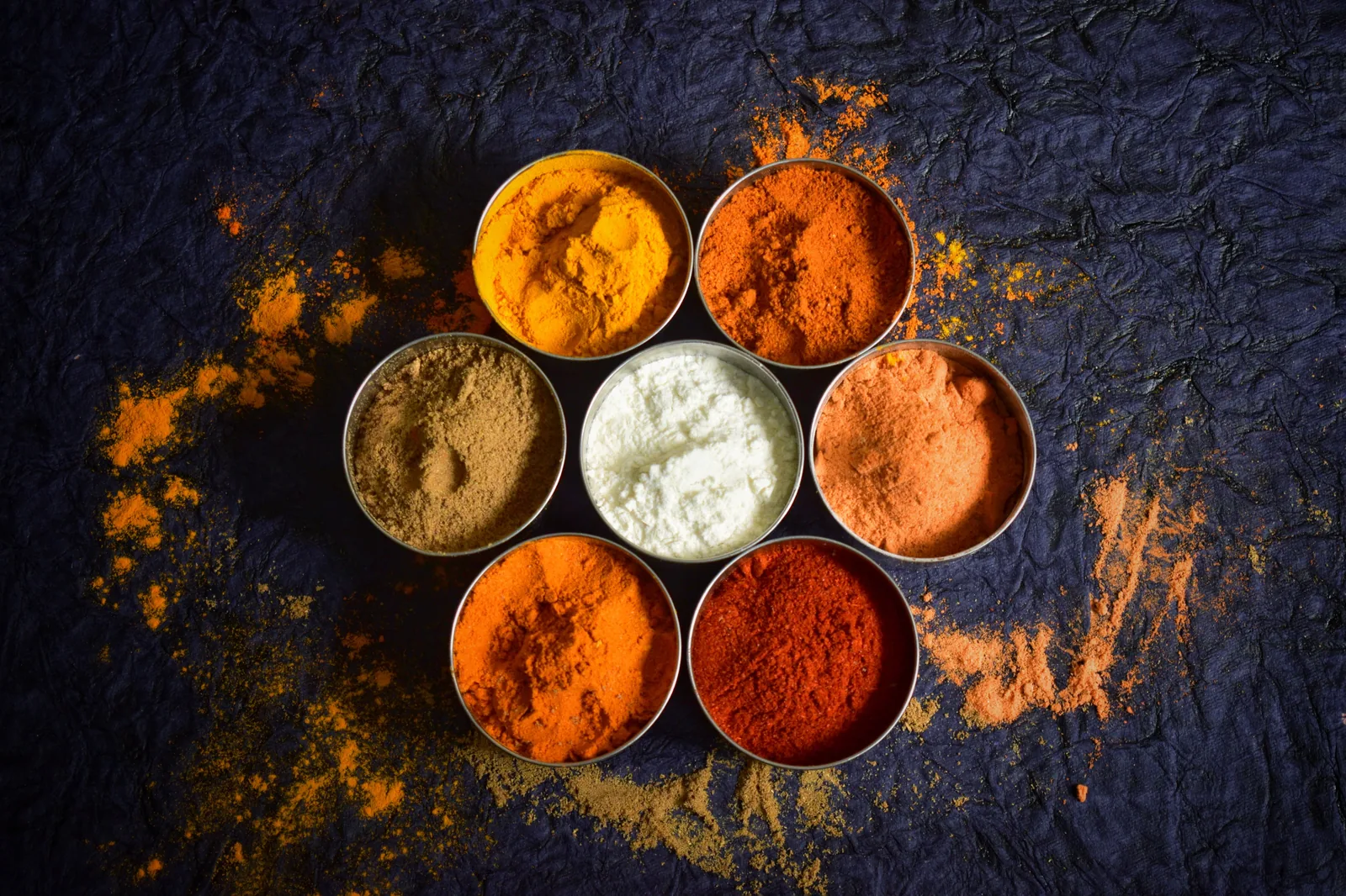 Bowls of ground spices in warm colours